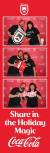 3 panel print photo booth picture of a couple posing with props in the Coca-Cola Killington branded backdrop photo booth with a Share in the Holiday Magic frame