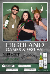 3 people posing with props on a Laphroaig Whiskey branded backdrop photo booth with a custom Highland Games & Festival frame