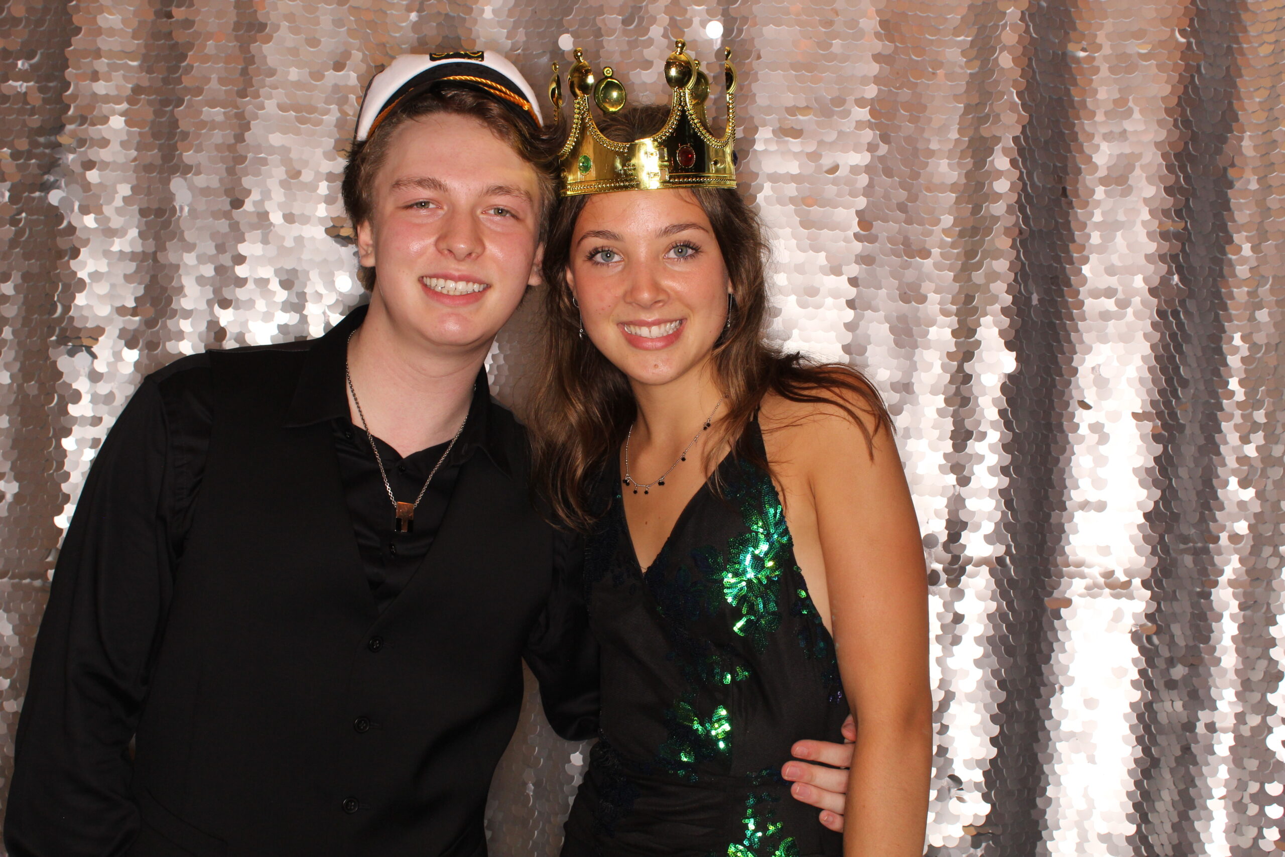 2 high schoolers in a Woodstock, Vermont prom photo booth wearing photo booth props